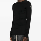 Black shirt worn by a person, showing the shirt fit