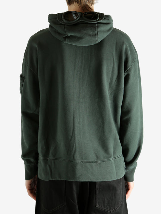 Green hoodie worn by a person, showing the hoodie's fit