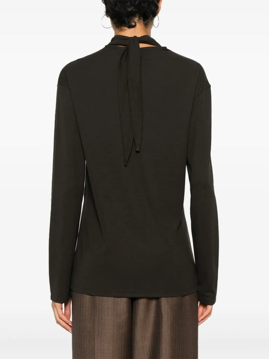 Brown top worn by a person, showing the top's fit