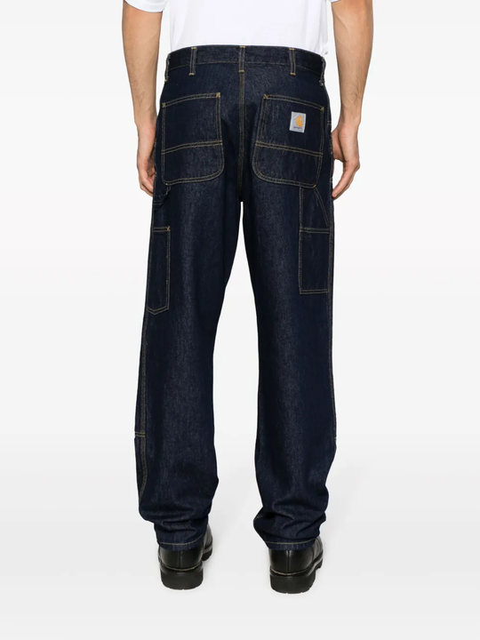 Black pants worn by a person, showing the pants fit