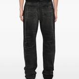 Black jeans worn by a person, showing the jeans' fit