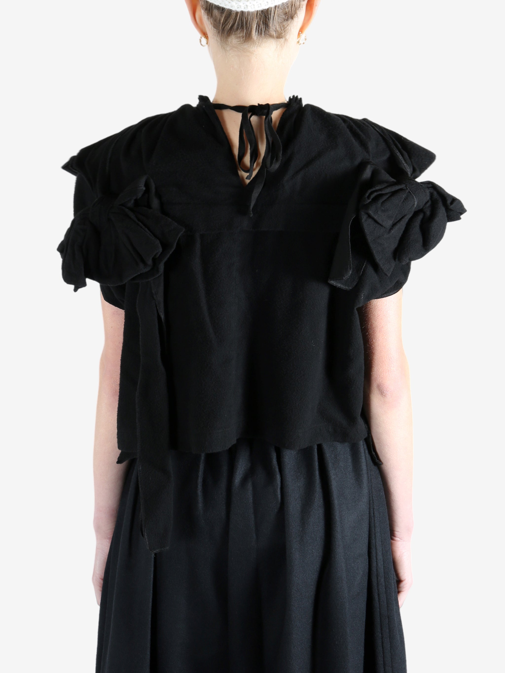 Black blouse worn by a person, showing the blouse's fit