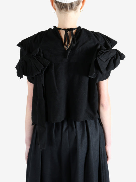 Black blouse worn by a person, showing the blouse's fit