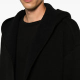 Black hoodie worn by a person, showing the hoodie fit