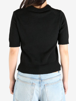 Black tee worn by a person, showing the tee's fit