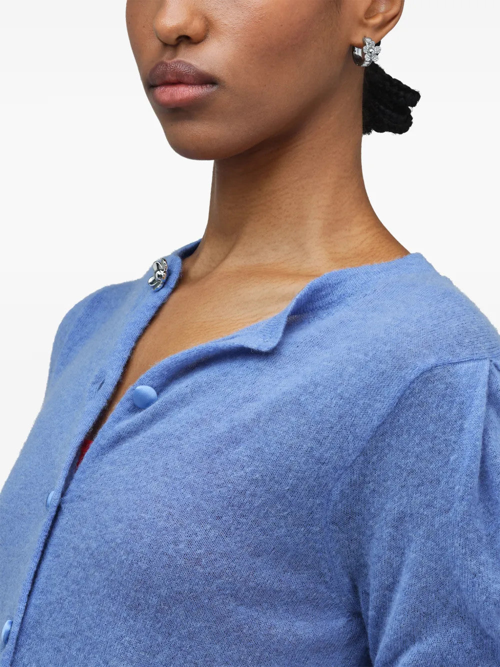 White jewelry worn by a person, showing the jewelry fit