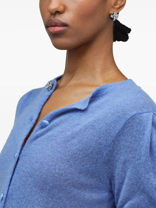 White jewelry worn by a person, showing the jewelry fit