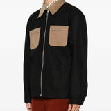 Black jacket worn by a person, showing the jacket fit