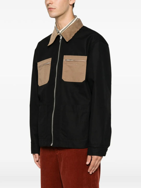 Black jacket worn by a person, showing the jacket fit