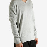 Grey sweater worn by a person, showing the sweater's fit