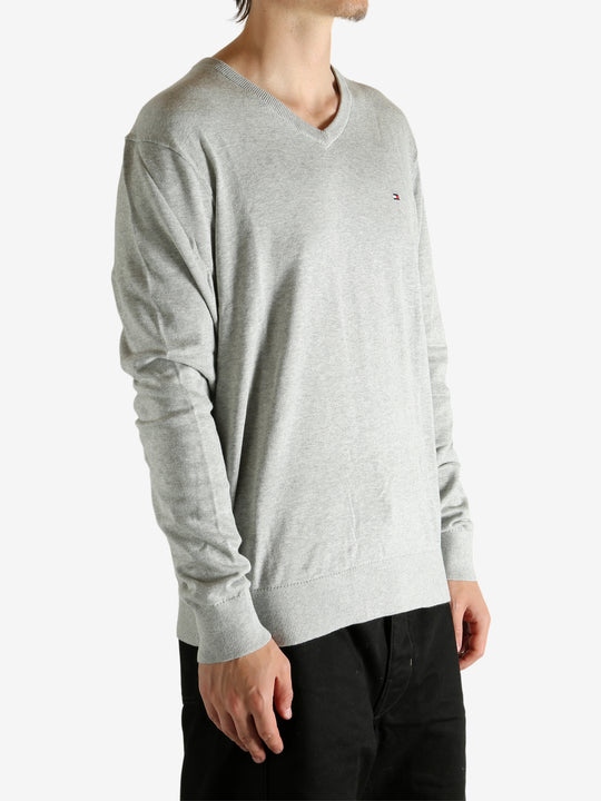 Grey sweater worn by a person, showing the sweater's fit