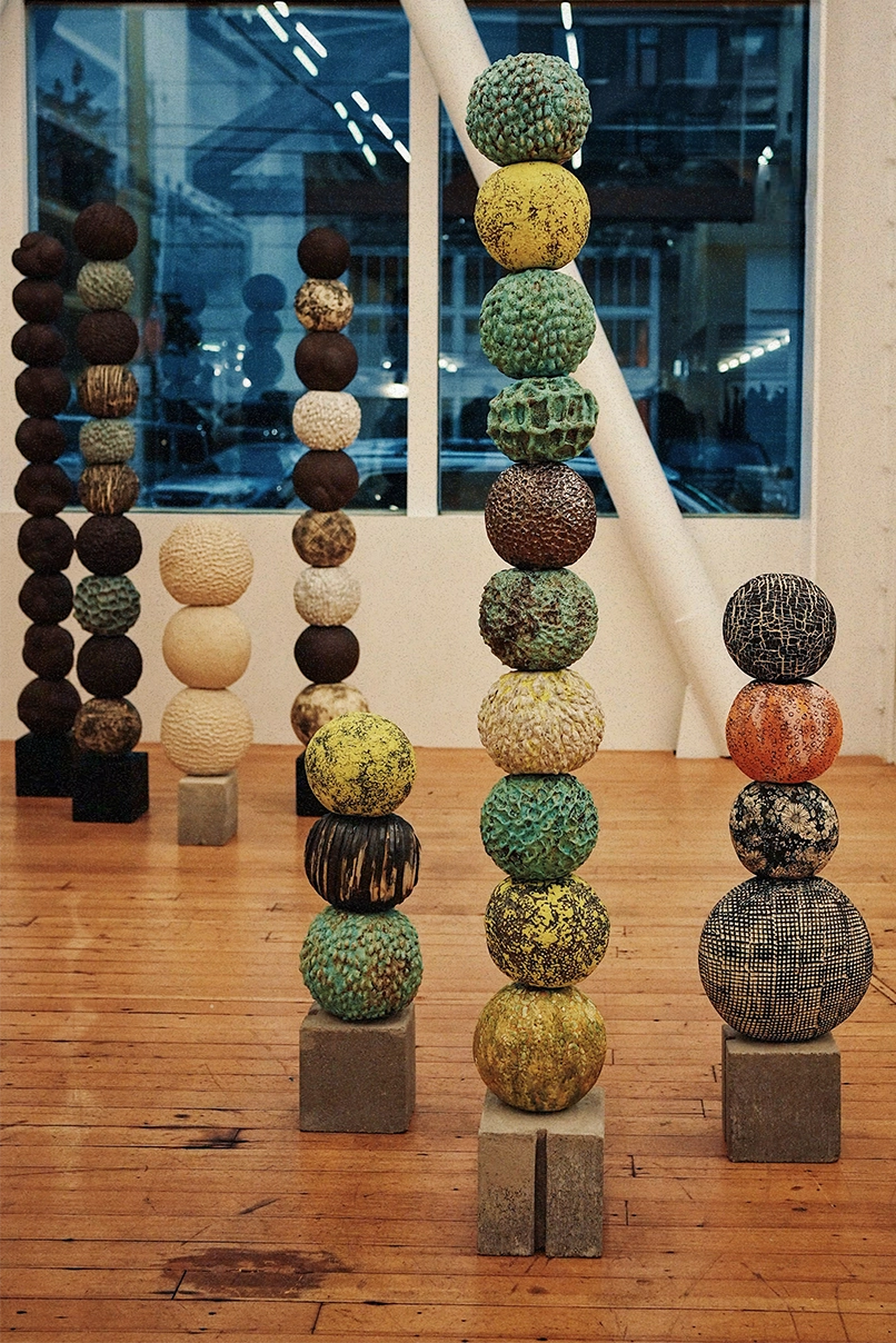 Seven ceramic sculptures by Ann Shure in stoneware, terracotta, porcelain, and raku on concrete and steel bases.