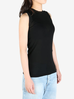 Black tee worn by a person, showing the tee's fit