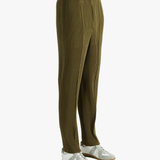 Green pants worn by a person, showing the pants' fit