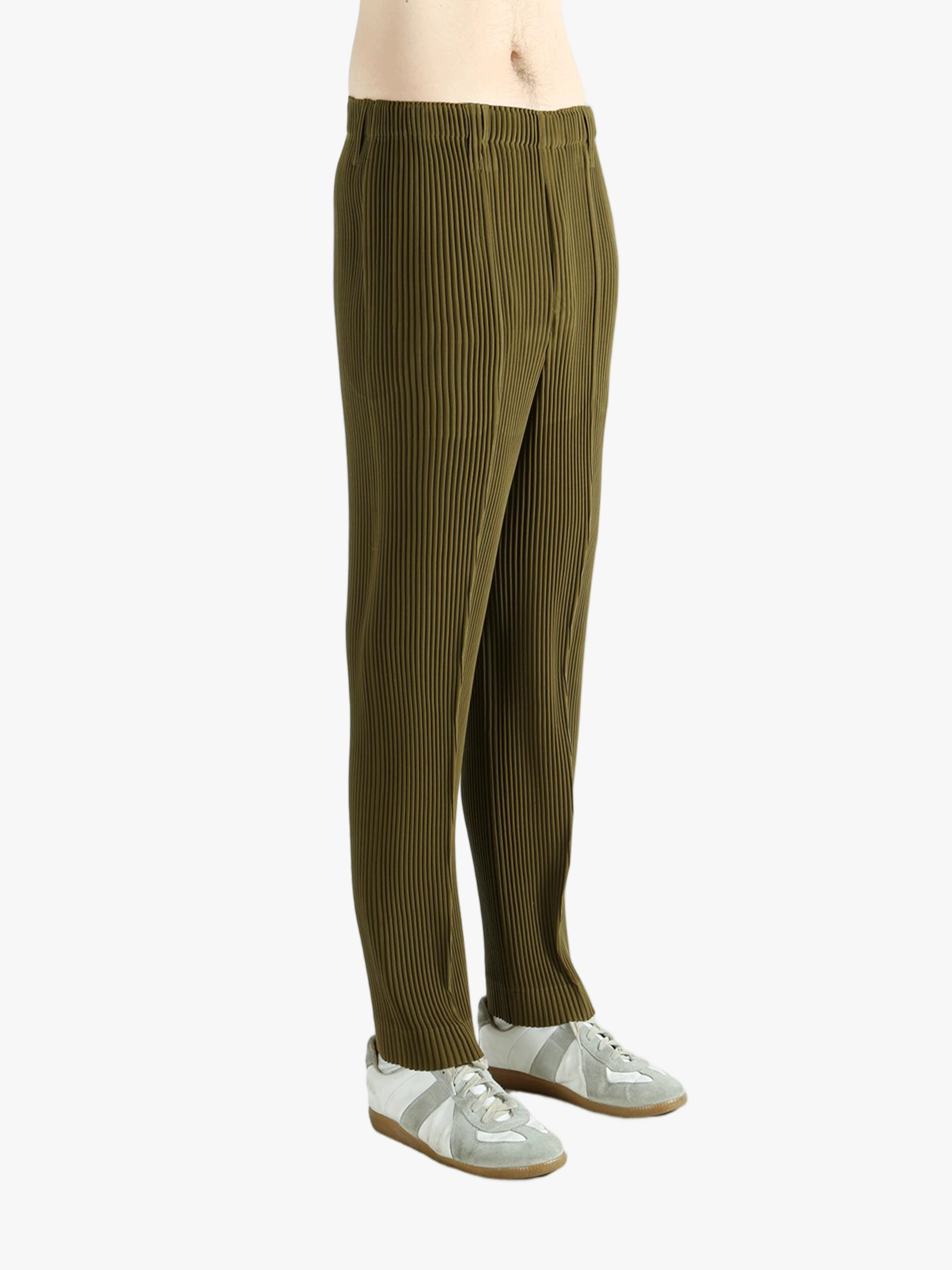 Green pants worn by a person, showing the pants' fit