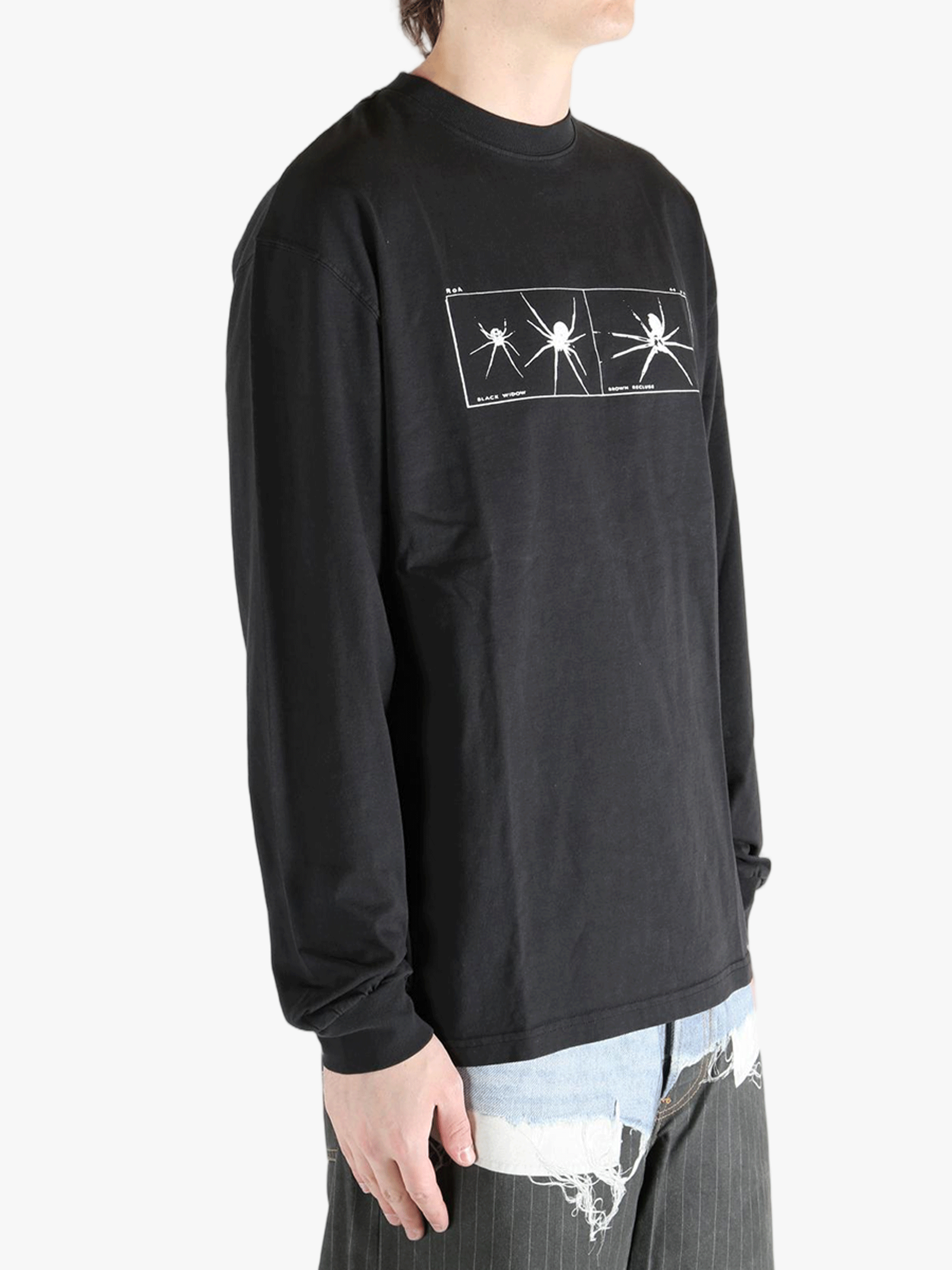 Black long-sleeve shirt worn by a person, showing the shirt's fit