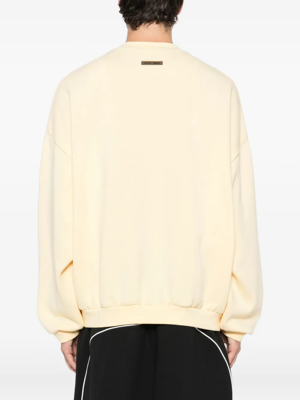 Yellow sweater worn by a person, showing the sweater fit