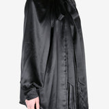 Black shirt worn by a person, showing the shirt fit