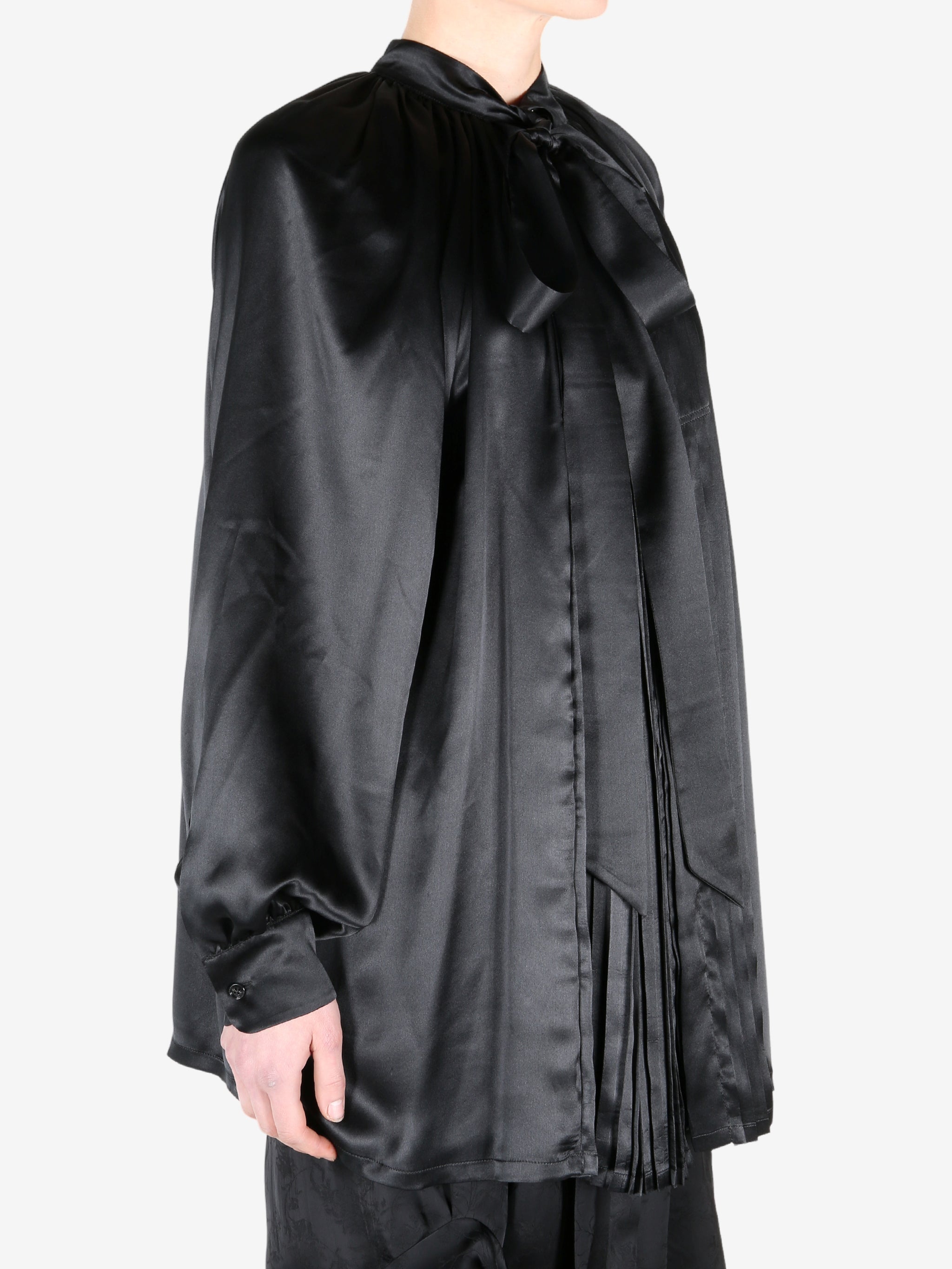 Black shirt worn by a person, showing the shirt fit