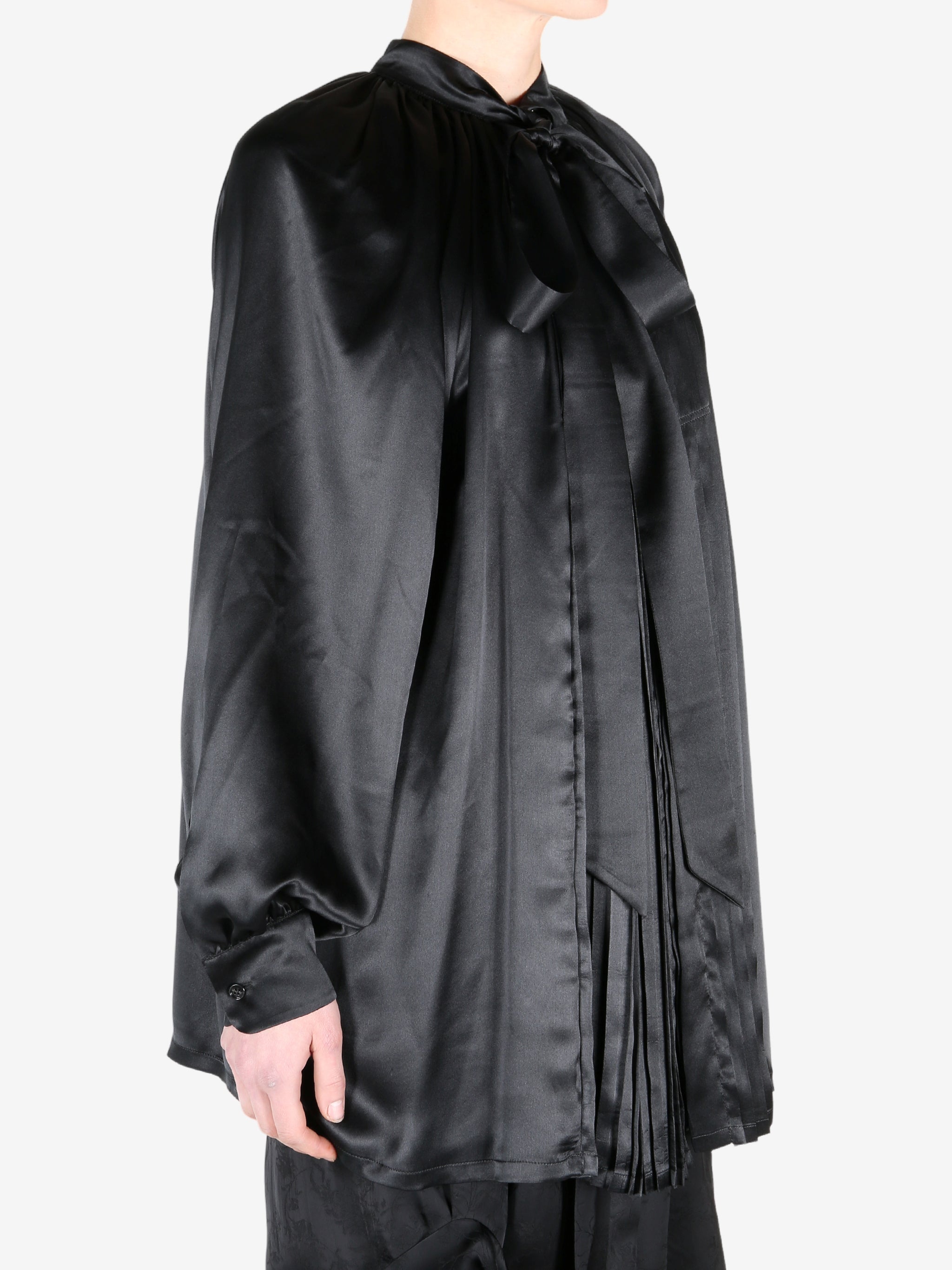 Black shirt worn by a person, showing the shirt fit