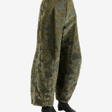 Green pants worn by a person, showing the pants' fit