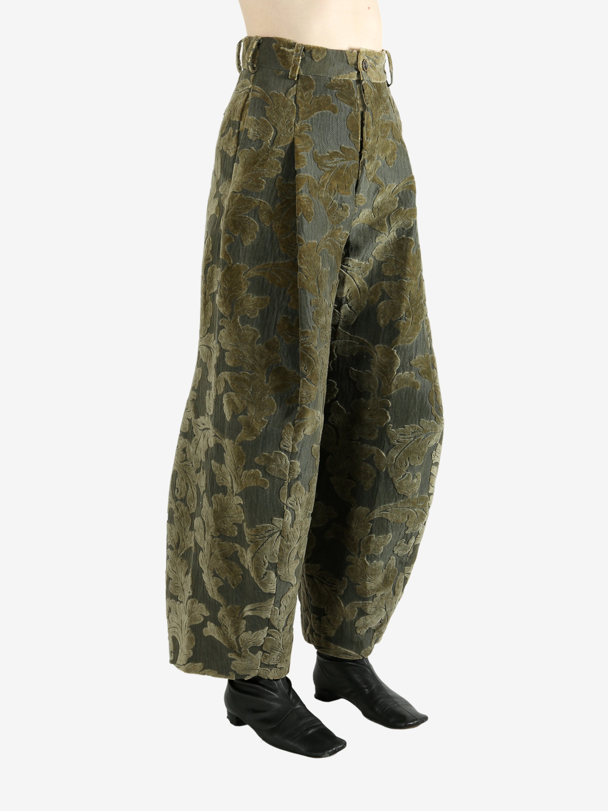 Green pants worn by a person, showing the pants' fit