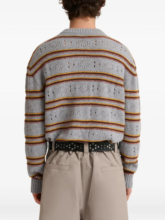 Grey knitwear worn by a person, showing the knitwear fit