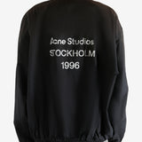 Black coat worn by a person, showing the coat's fit