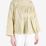 Tan shirt worn by a person, showing the shirt fit