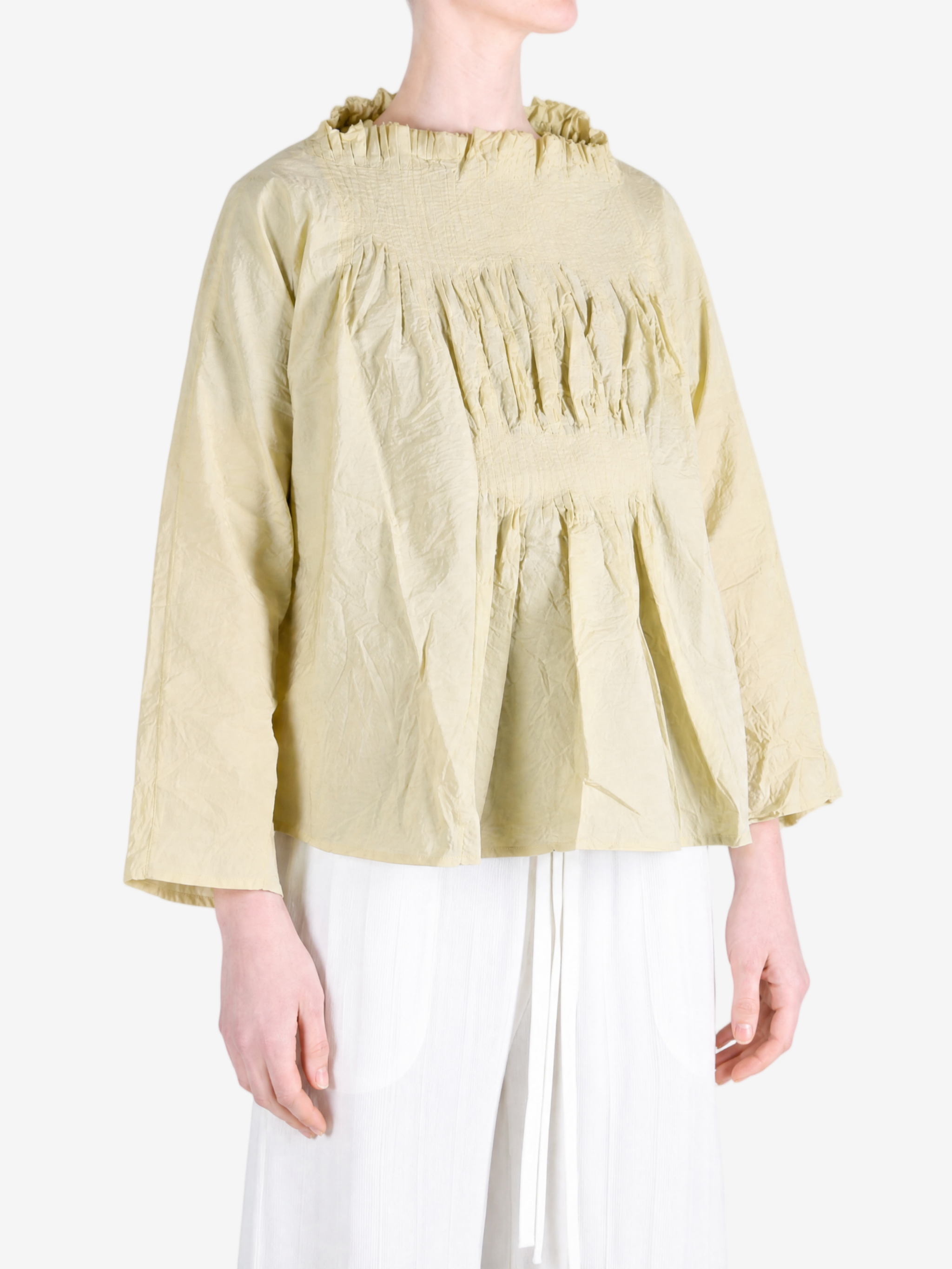 Tan shirt worn by a person, showing the shirt fit