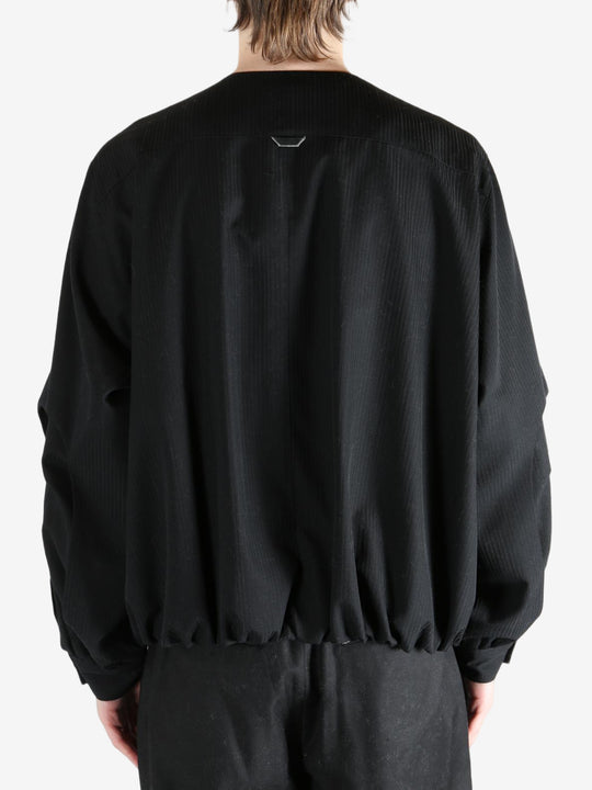 Black coats worn by a person, showing the coats fit