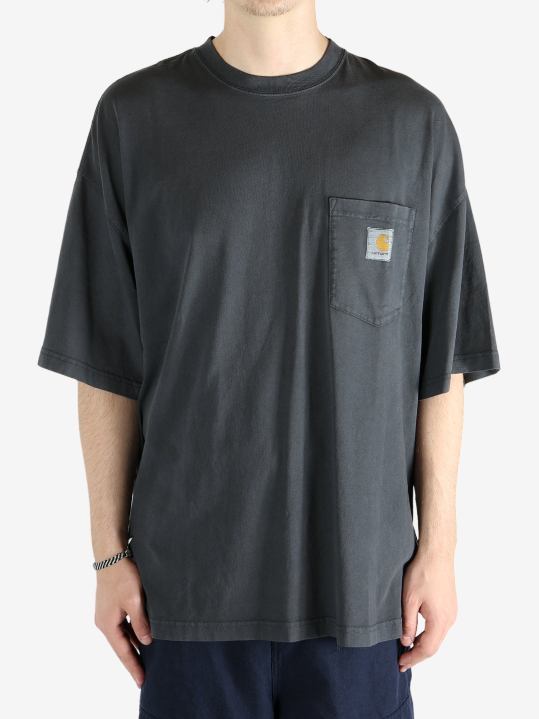 Black t-shirt worn by a person, showing the t-shirt's fit