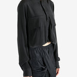 Black shirt worn by a person, showing the shirt's fit