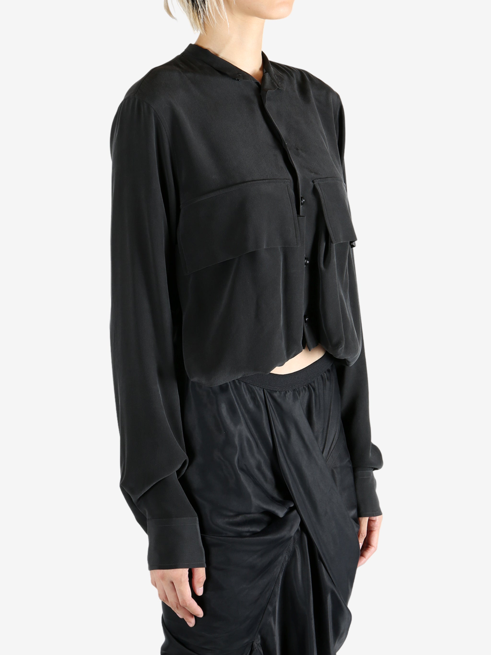 Black shirt worn by a person, showing the shirt's fit