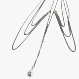 Close up of grey necklace, showing texture of the silver fabric