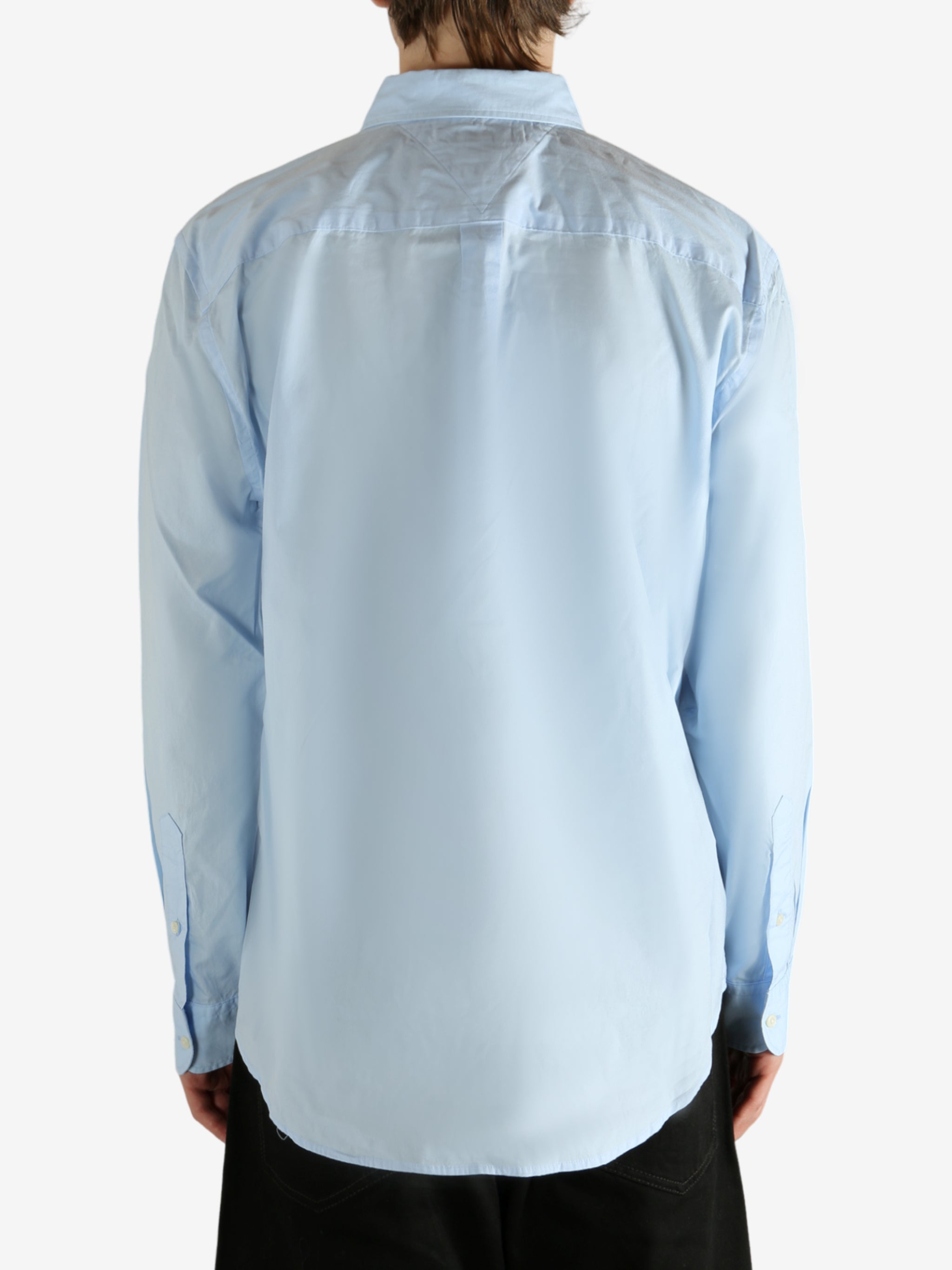 Blue shirt worn by a person, showing the shirt's fit