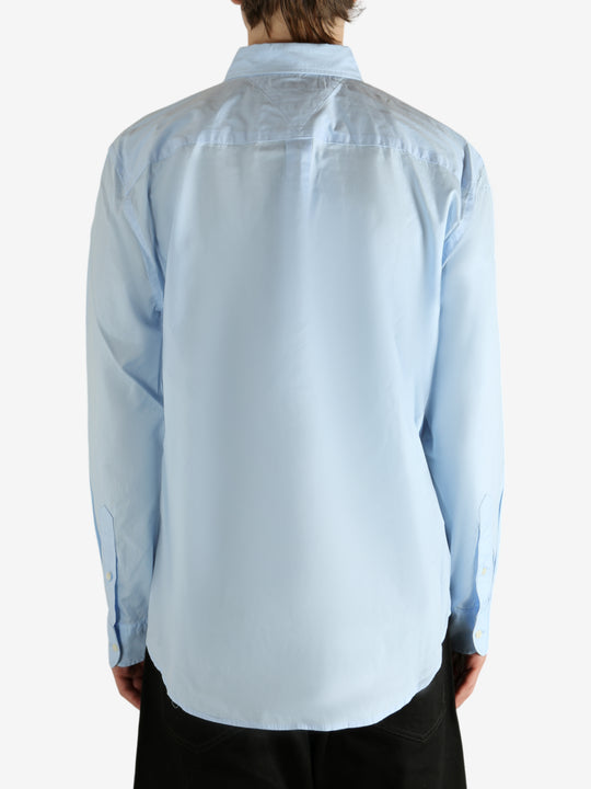 Blue shirt worn by a person, showing the shirt's fit