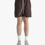 Brown shorts worn by a person, showing the shorts's fit