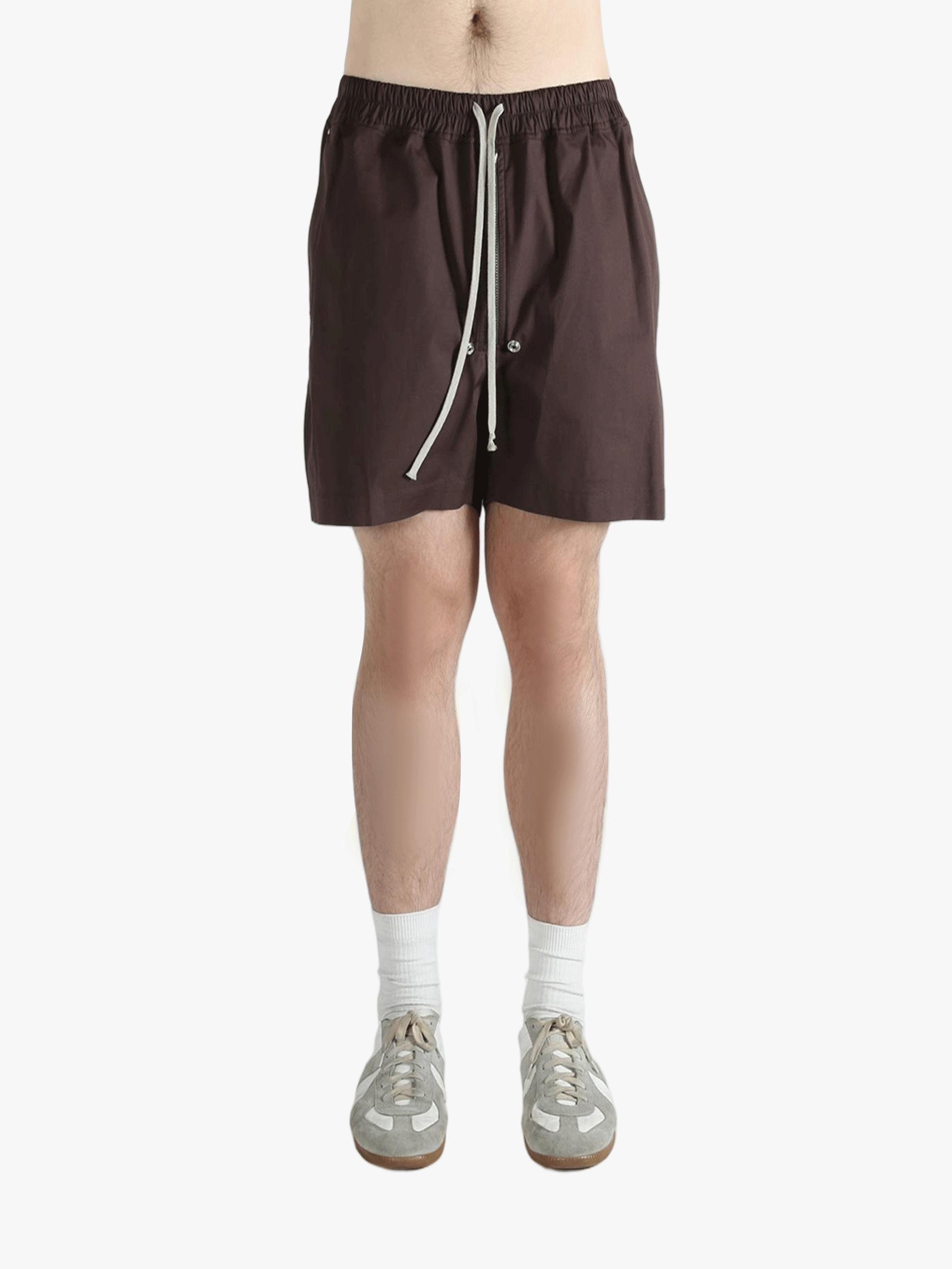 Brown shorts worn by a person, showing the shorts's fit