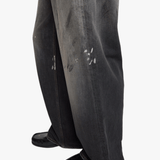 Black jeans worn by a person, showing the jeans fit