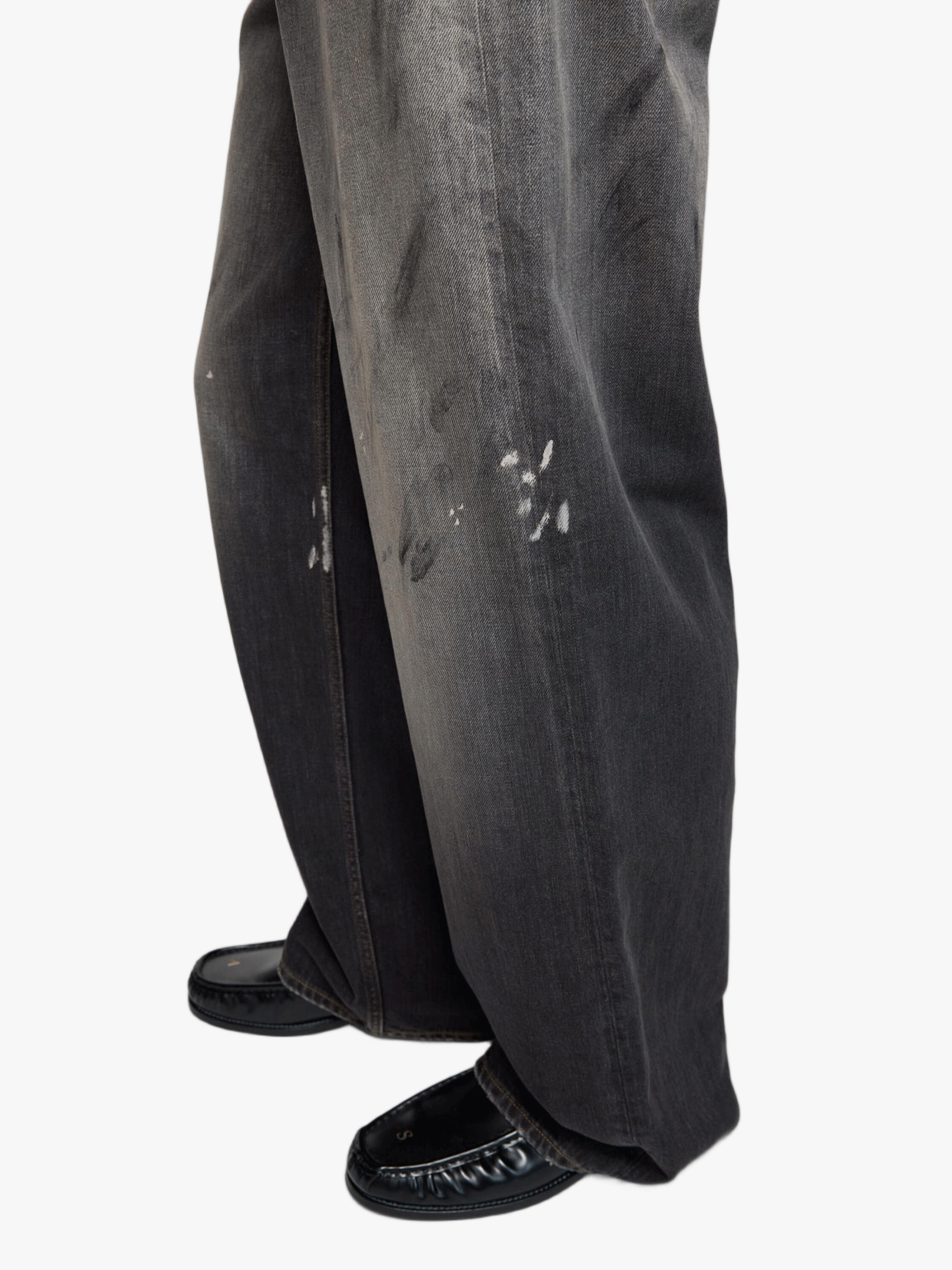 Black jeans worn by a person, showing the jeans fit