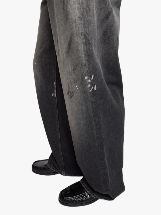 Black jeans worn by a person, showing the jeans fit