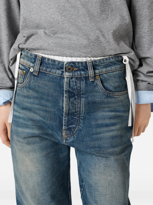 Blue jeans worn by a person, showing the jeans fit
