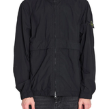 Black jacket worn by a person, showing the black jacket's fit