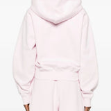 Pink hoodie worn by a person, showing the hoodie's fit