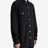 Black shirt worn by a person, showing the shirt fit