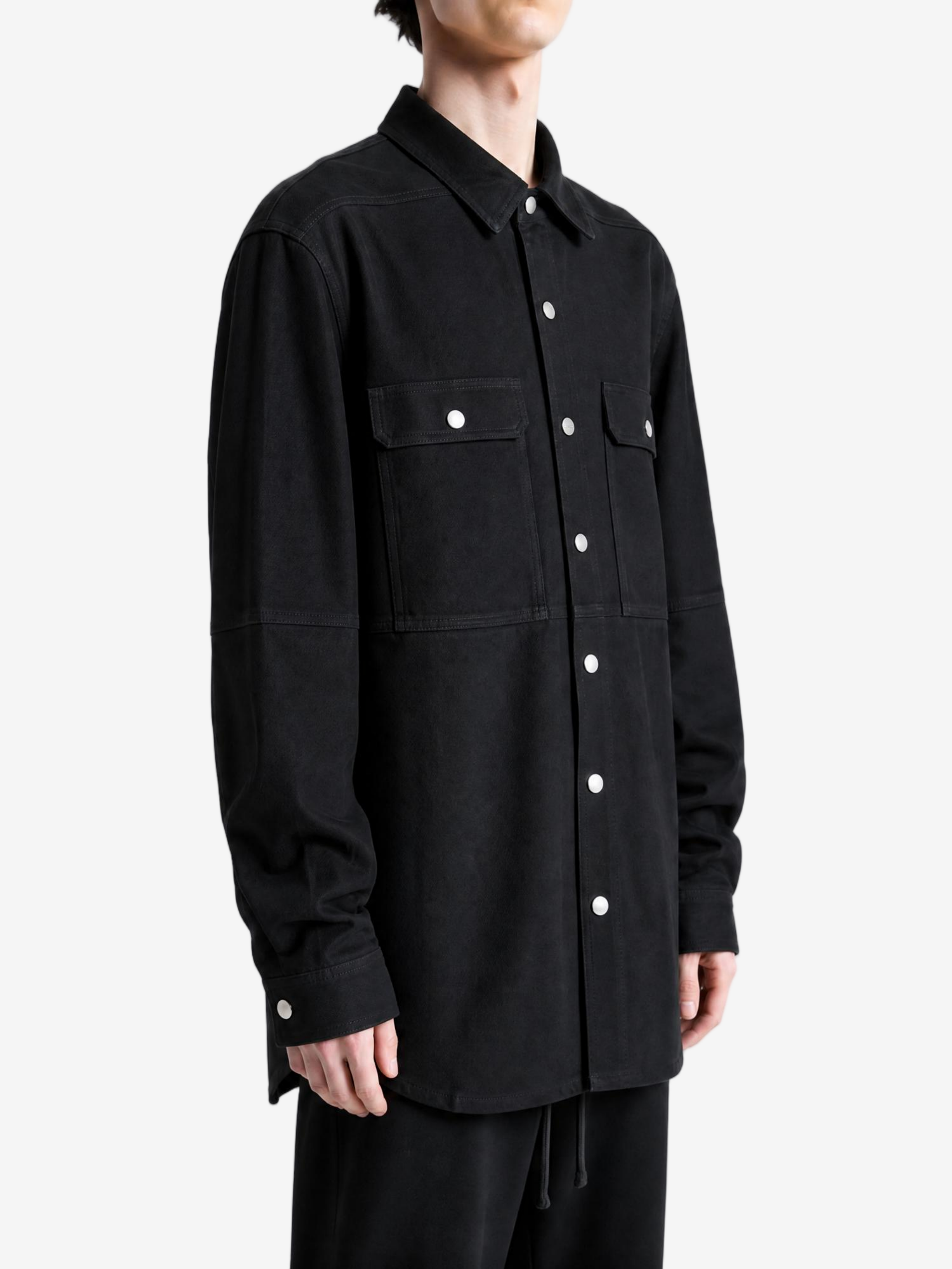 Black shirt worn by a person, showing the shirt fit