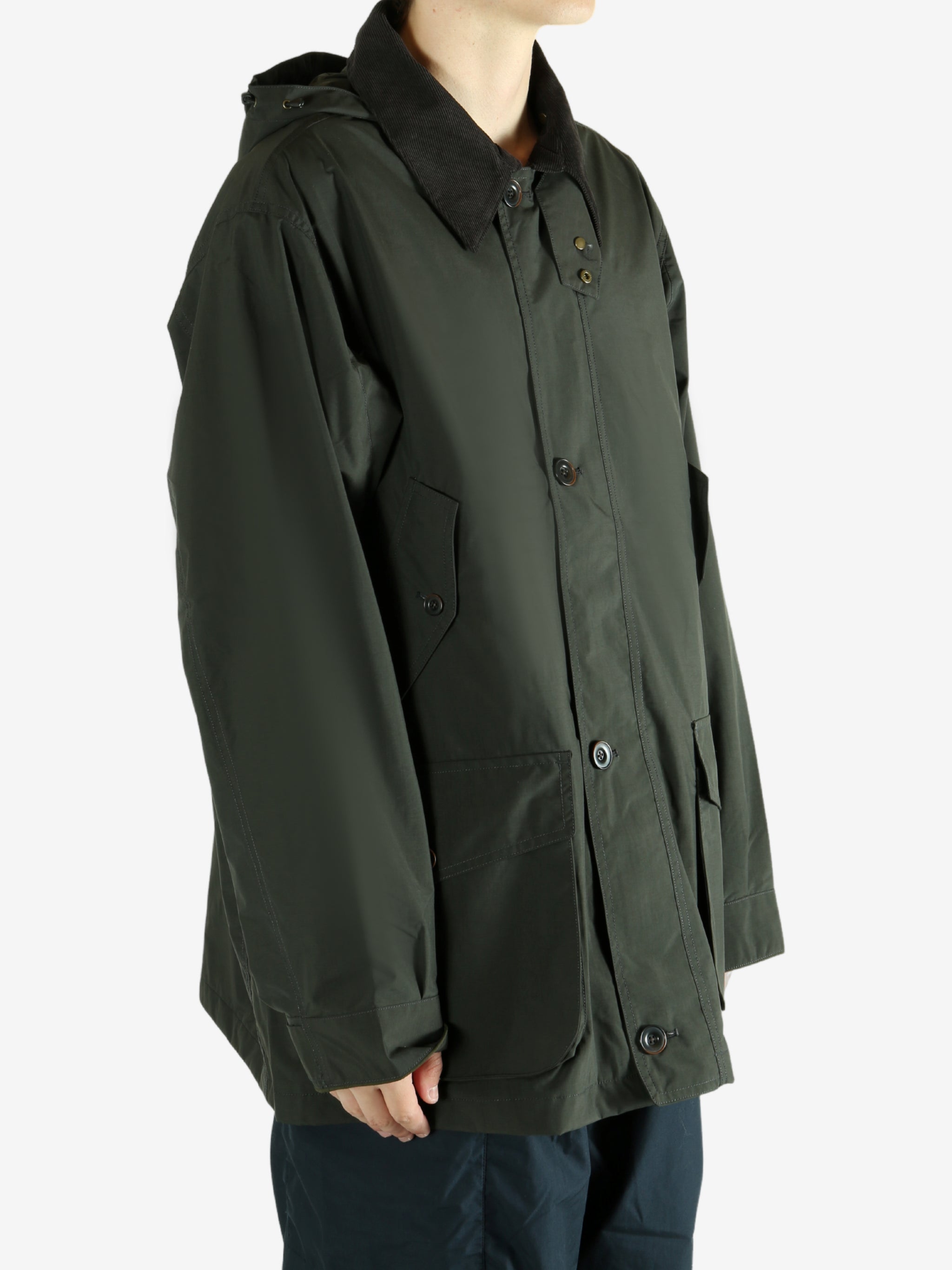 Green jacket worn by a person, showing the jacket's fit