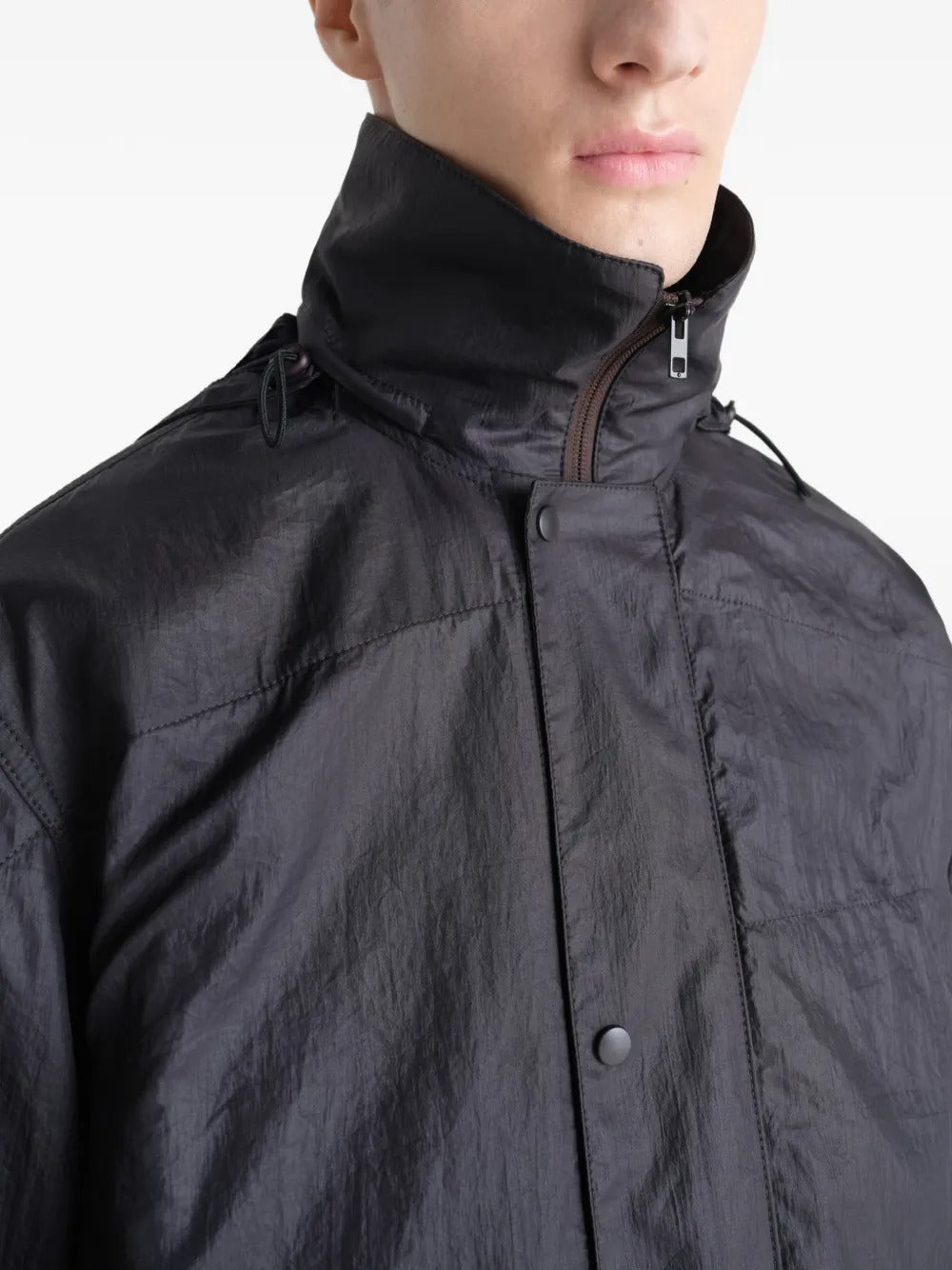 Close up of the black coat, showing texture of the nylon fabric