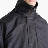 Close up of the black coat, showing texture of the nylon fabric